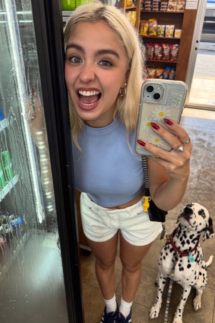 Creator taking a mirror selfie with her dog